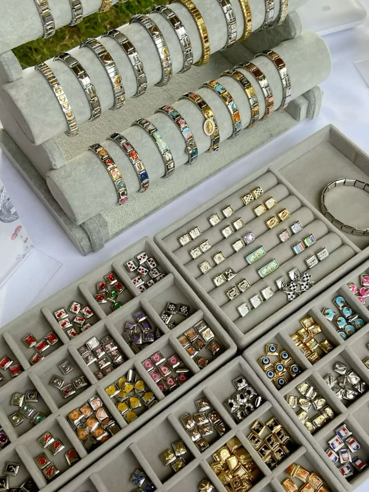 Italian charm bracelets and individual charm links prepared for inspection